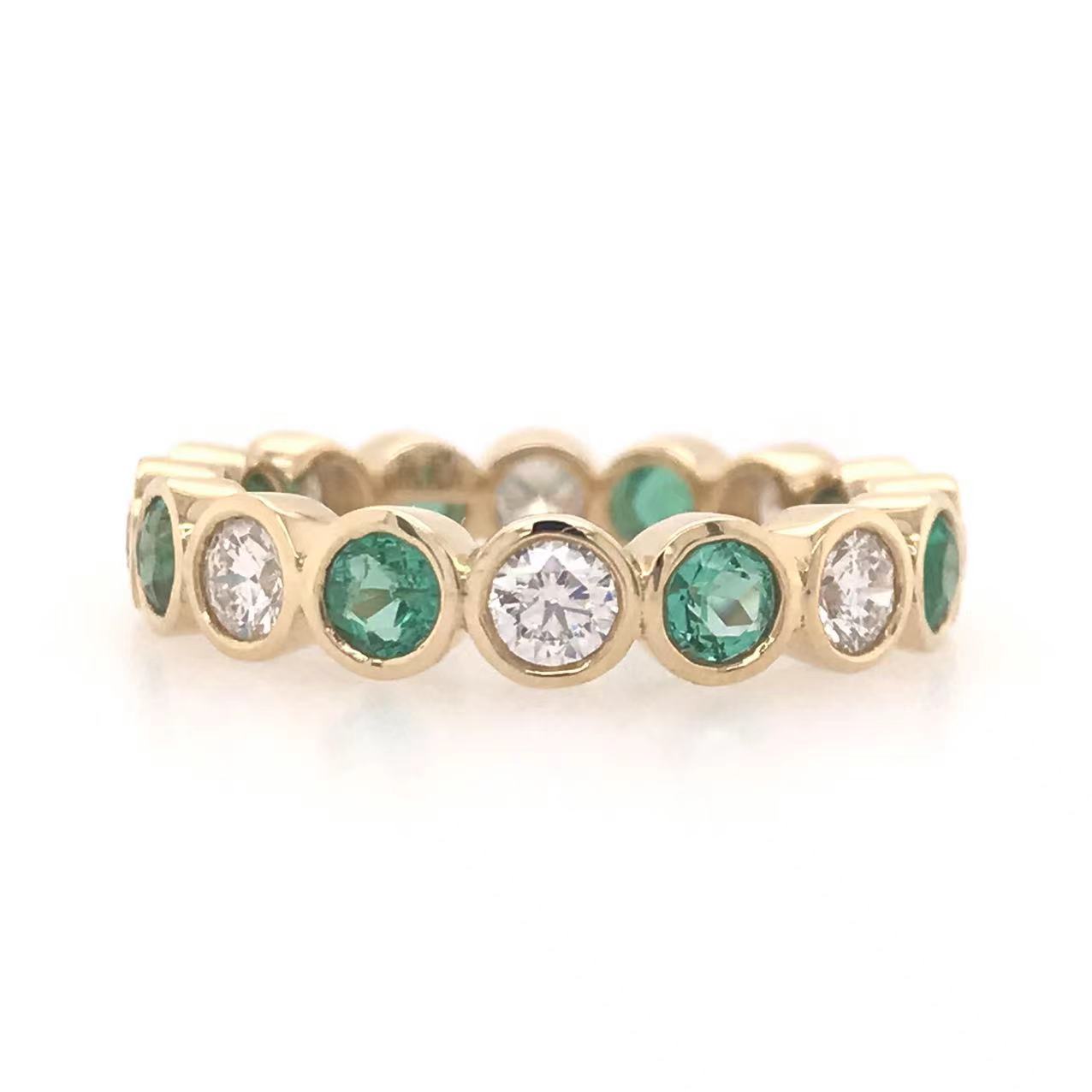 JARDIN EMERALD AND DIAMOND BEZEL ETERNITY RING